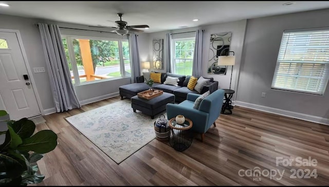 living room with ceiling fan, plenty of natural light, and hardwood / wood-style flooring