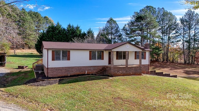 ranch-style house with a front lawn and central air condition unit