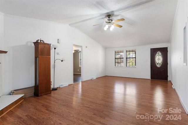 interior space with dark hardwood / wood-style floors, ceiling fan, ornamental molding, and lofted ceiling with beams