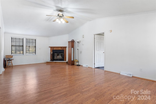 unfurnished living room featuring lofted ceiling, ceiling fan, wood-type flooring, and crown molding