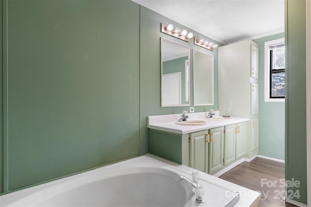 bathroom featuring hardwood / wood-style floors, a bathing tub, ornamental molding, and a textured ceiling