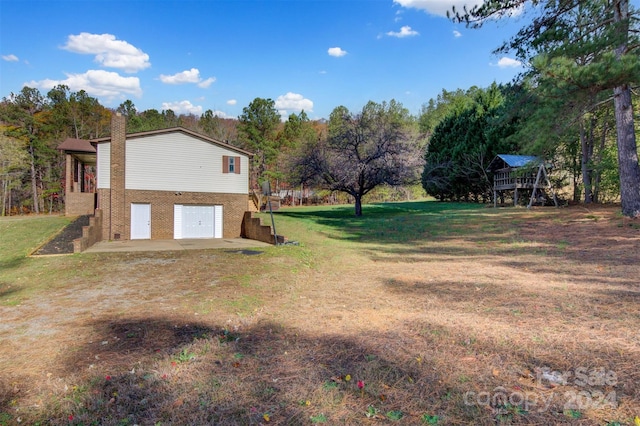 view of side of property with a lawn and a patio area