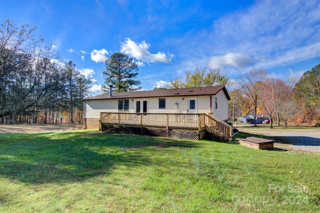 back of house featuring a deck and a yard