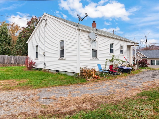 view of home's exterior featuring a yard