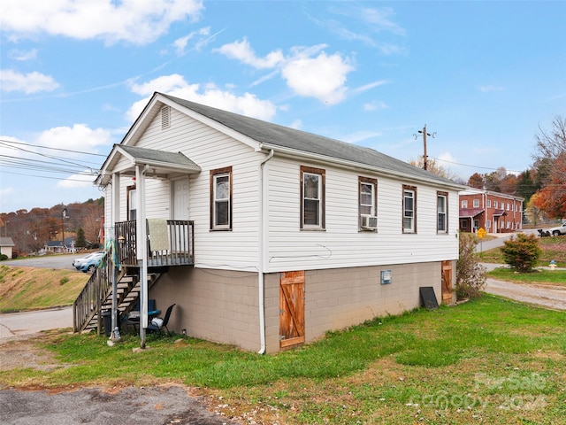 view of side of property featuring a yard and cooling unit