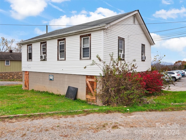 view of side of property with a yard