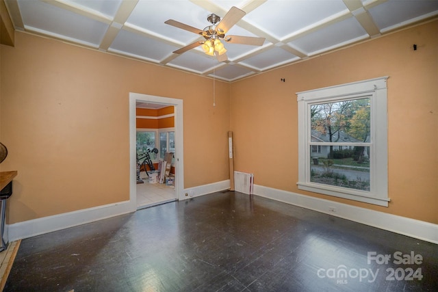 spare room with ceiling fan and coffered ceiling