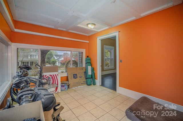 misc room featuring beam ceiling, coffered ceiling, and light tile patterned flooring