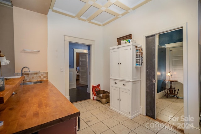 interior space featuring light tile patterned flooring and sink