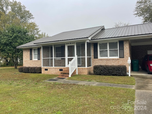 ranch-style home with a front yard and a carport