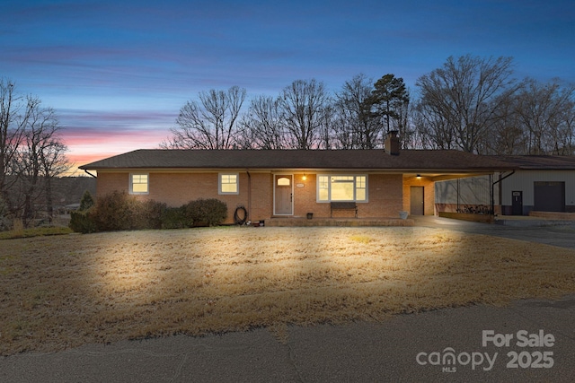 ranch-style home featuring a carport