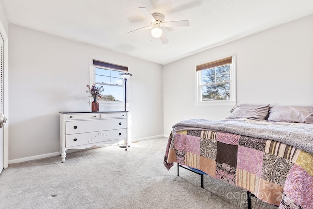 bedroom with ceiling fan and light colored carpet