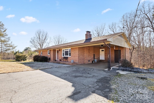 ranch-style home featuring a carport