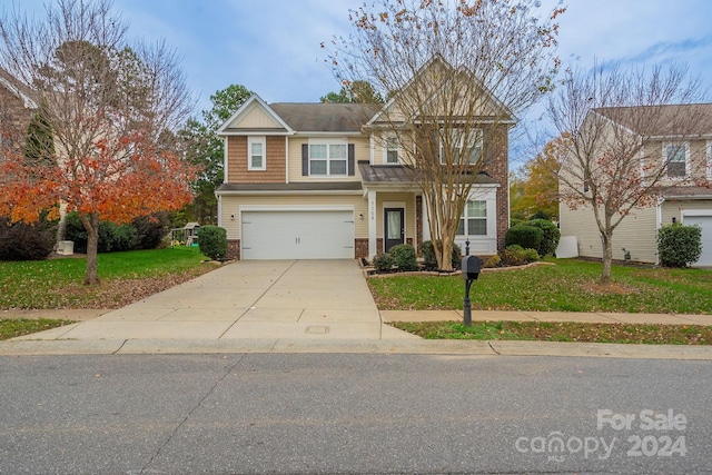 view of front of house featuring a front yard and a garage