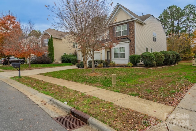 view of front of house with a garage and a front lawn