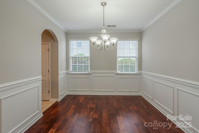 unfurnished dining area with arched walkways, a wealth of natural light, dark wood finished floors, and visible vents