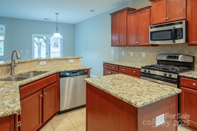 kitchen featuring a kitchen island, a sink, light stone countertops, stainless steel appliances, and backsplash