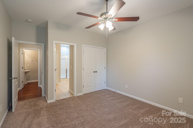 unfurnished bedroom with a ceiling fan, carpet, baseboards, and a closet