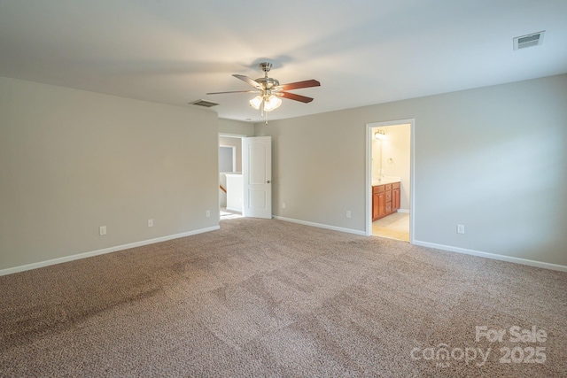 empty room featuring baseboards, visible vents, and light colored carpet