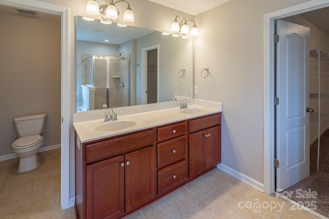 full bathroom featuring double vanity, tile patterned flooring, a shower stall, and a sink