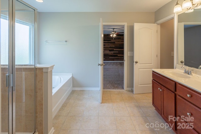 full bath featuring tile patterned floors, an enclosed shower, vanity, baseboards, and a bath