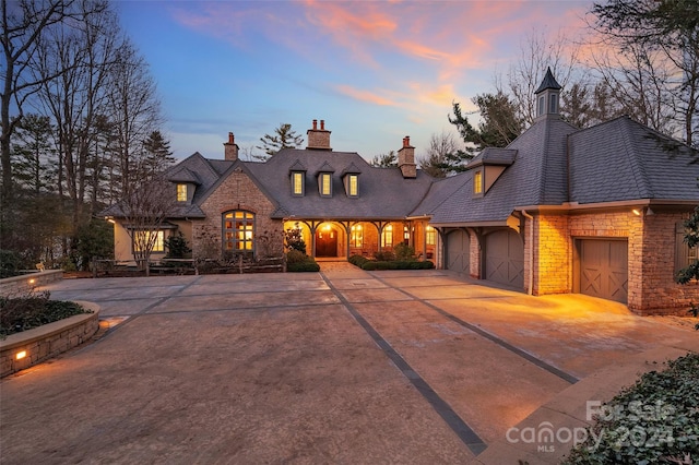 french country style house with a garage