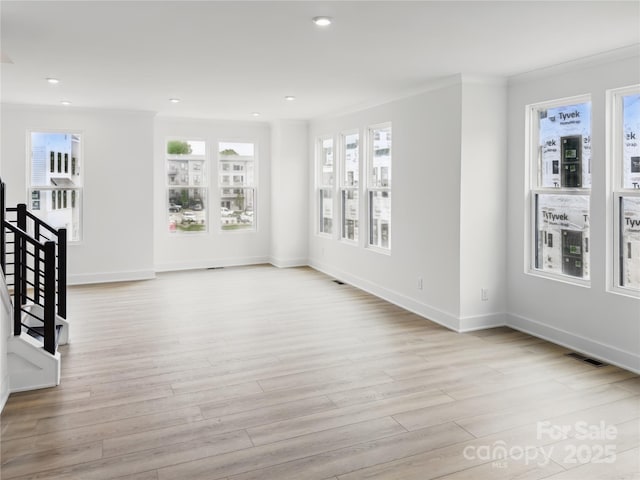 unfurnished living room with recessed lighting, stairs, light wood-style floors, baseboards, and visible vents