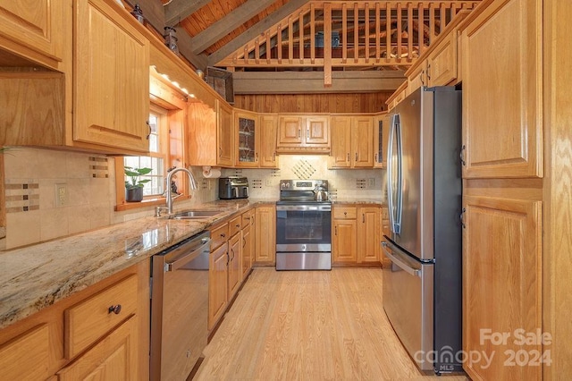 kitchen featuring light stone countertops, sink, wooden ceiling, stainless steel appliances, and light wood-type flooring