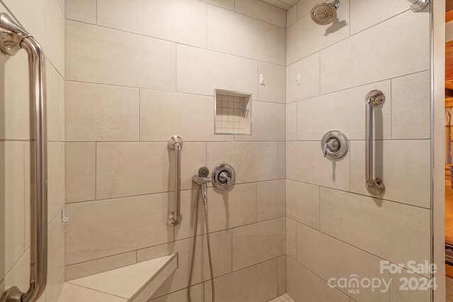 bathroom with tiled shower