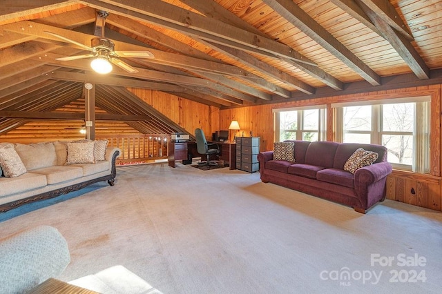 carpeted living room featuring lofted ceiling with beams, wooden walls, ceiling fan, and wooden ceiling