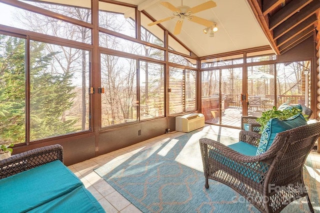 sunroom featuring a wall mounted air conditioner, ceiling fan, and vaulted ceiling