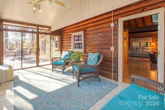 sunroom featuring vaulted ceiling and ceiling fan