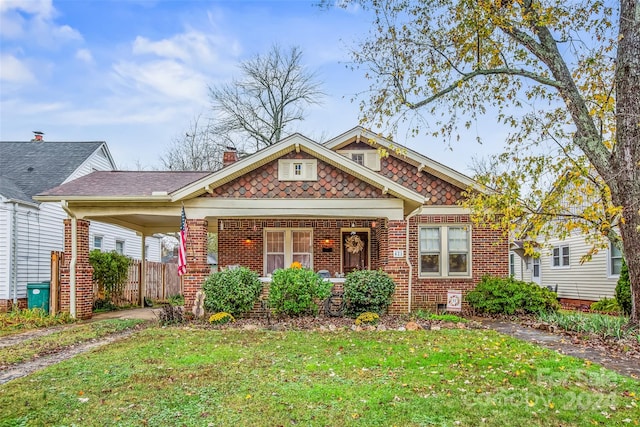 view of front facade with a front yard and a porch