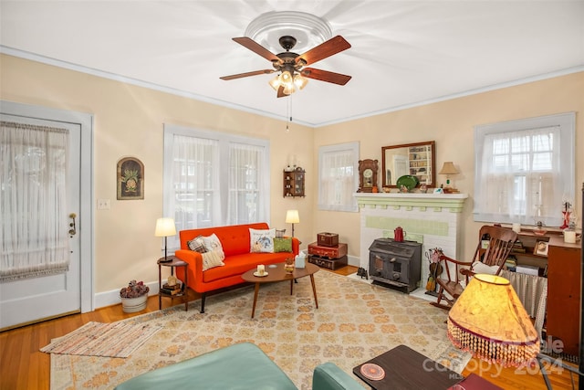 living room with crown molding, ceiling fan, and wood-type flooring