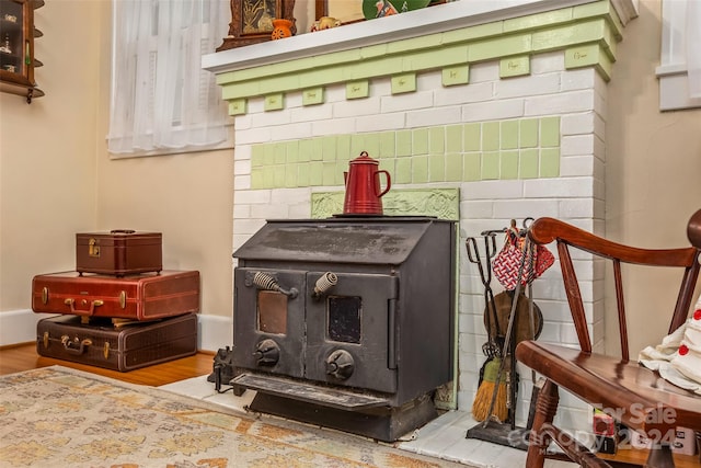 interior details featuring wood-type flooring and a wood stove