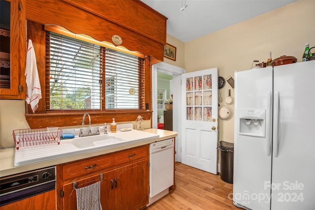 kitchen with light wood-type flooring and white appliances