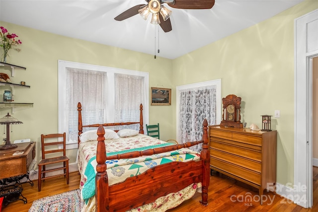 bedroom with hardwood / wood-style floors and ceiling fan