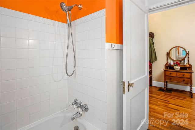 bathroom featuring wood-type flooring and tiled shower / bath combo