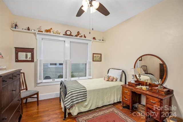 bedroom with ceiling fan and hardwood / wood-style flooring