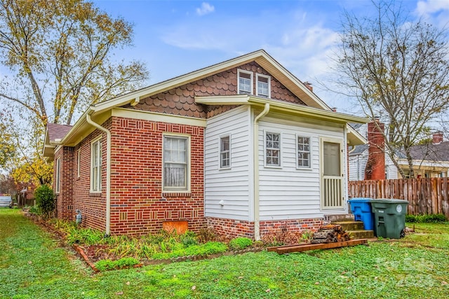 view of side of home featuring a yard