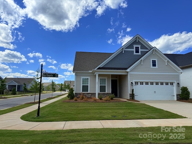 405 Northgate Blvd, Indian Trail, NC 28079 - craftsman inspired home with concrete driveway, stone siding, a front lawn, and an attached garage