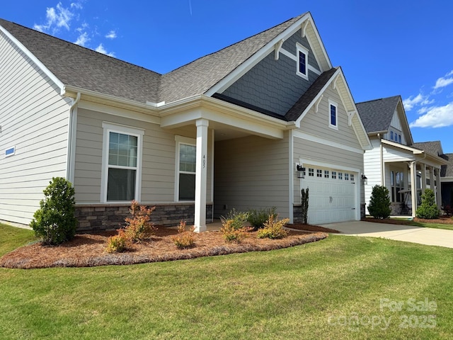 405 Northgate Blvd, Indian Trail, NC 28079 - view of front of home with a front lawn, concrete driveway, roof with shingles, and stone siding