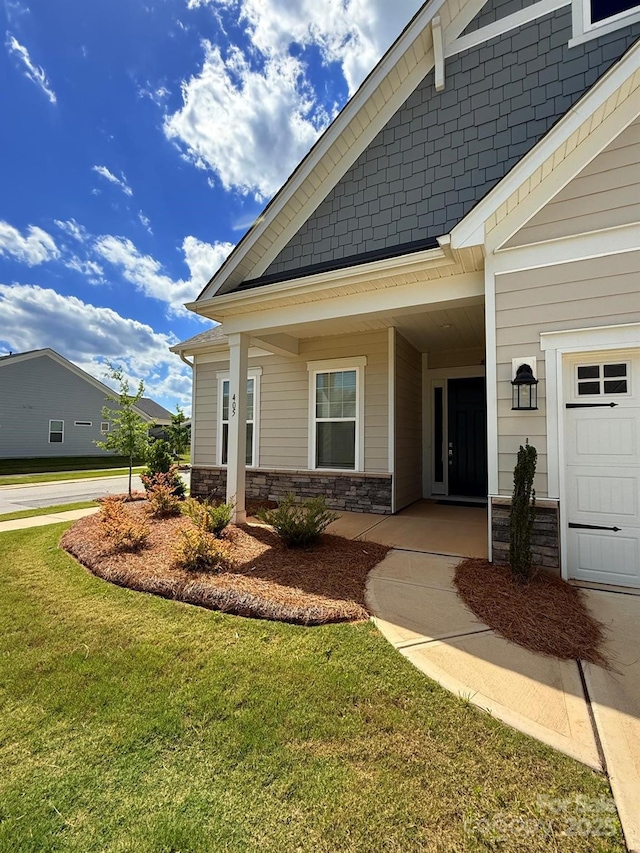 405 Northgate Blvd, Indian Trail, NC 28079 - view of side of property with a lawn, stone siding, and a garage