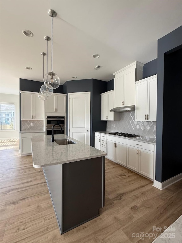 405 Northgate Blvd, Indian Trail, NC 28079 - kitchen featuring a sink, tasteful backsplash, light wood-type flooring, white cabinets, and recessed lighting