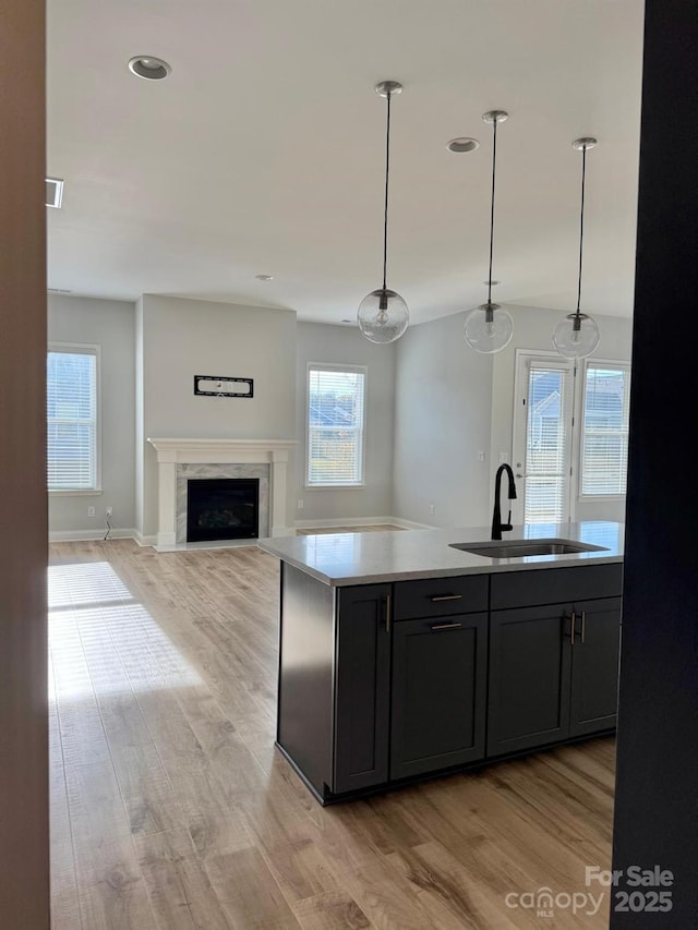 405 Northgate Blvd, Indian Trail, NC 28079 - kitchen with a sink, light wood finished floors, a fireplace, decorative light fixtures, and recessed lighting