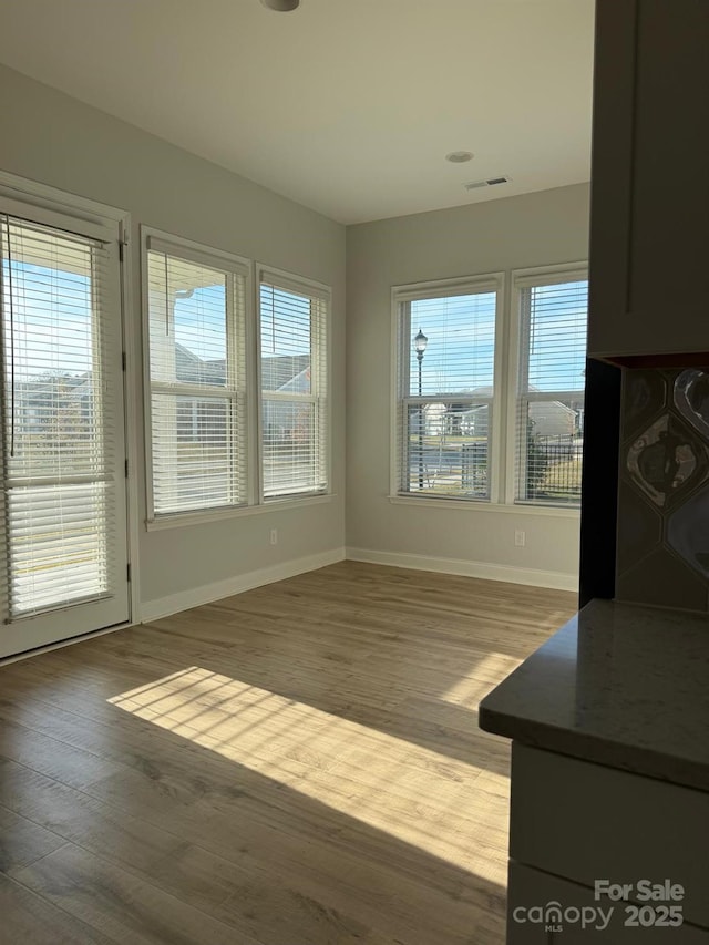 405 Northgate Blvd, Indian Trail, NC 28079 - unfurnished dining area featuring baseboards, wood finished floors, and plenty of natural light