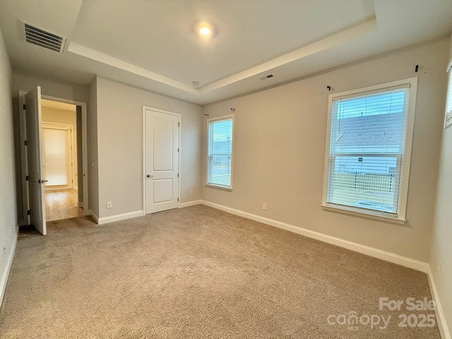 405 Northgate Blvd, Indian Trail, NC 28079 - unfurnished bedroom with a raised ceiling, baseboards, and carpet floors