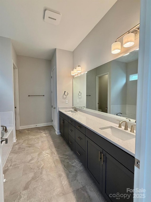405 Northgate Blvd, Indian Trail, NC 28079 - full bath featuring double vanity, a garden tub, and baseboards