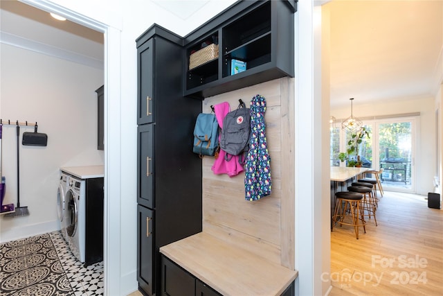 mudroom with washer and dryer, light wood-type flooring, an inviting chandelier, and crown molding