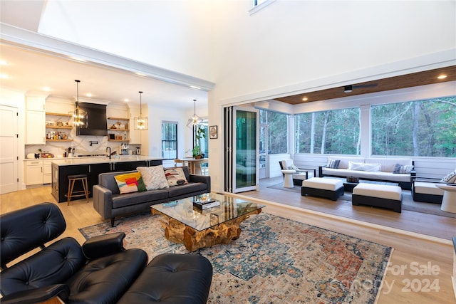 living room featuring light wood-type flooring and sink